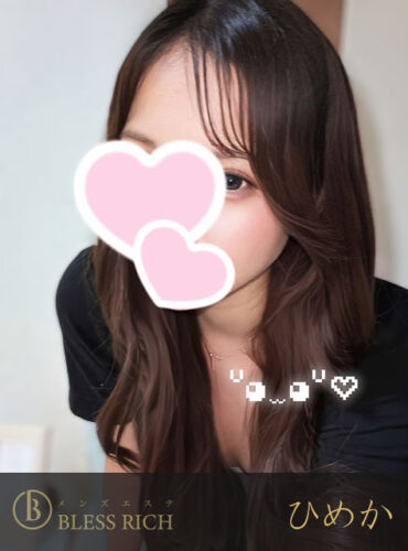 藤沢 メンズエステ｜完全個室 BLESS RICH（ブレスリッチ） Portrait of a woman with long brown hair, pink heart stickers over her nose, wearing a black top; Bless Rich branding in the corner.