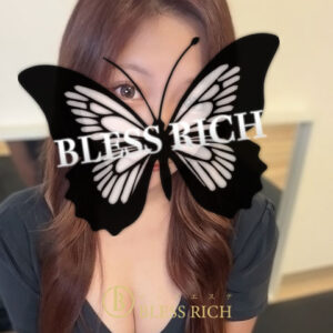 藤沢 メンズエステ｜完全個室 BLESS RICH（ブレスリッチ） Portrait of a woman with long brown hair, a large black butterfly graphic covering her face with the text 'BLESS RICH' across it and a gold 'BLESS RICH' logo near the bottom.